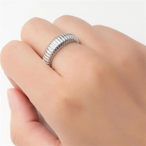 Macro shot of a 925 sterling silver ribbed ring with irregular wave texture