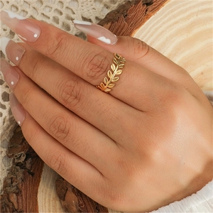 Elegant 925 sterling silver golden leaf ring on rustic wooden and lace background