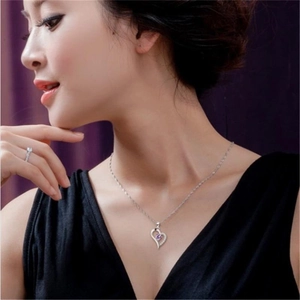 Macro detail of S925 sterling silver heart necklace with purple amethyst and zircon