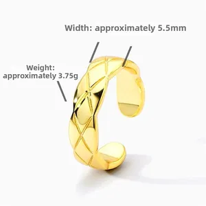 Detail of 5.5mm wide golden ring featuring classic quilted pattern and open design