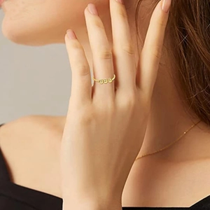 Detailed view of minimalist gold 925 silver ring featuring rotating micro beads on finger