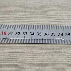 Macro shot of S925 sterling silver box chain earring with measurement on steel ruler