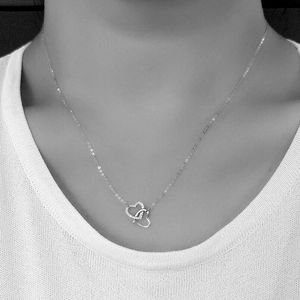 S925 sterling silver interlocking heart necklace with pavé diamonds on model
