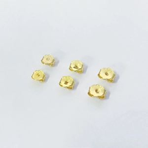 Close-up of six gold butterfly-shaped S925 sterling silver earring backs on white background