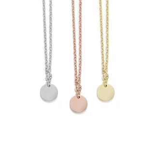 Detailed view of round disc pendants in silver, rose gold, and gold plating
