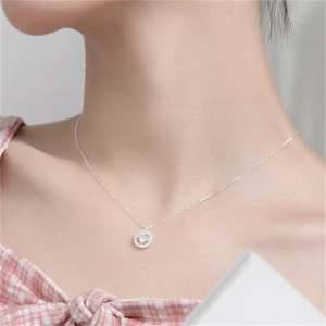Close-up of S925 sterling silver necklace with a sparkling round diamond halo pendant