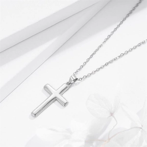 Minimalist S925 sterling silver cross pendant necklace on elegant white geometric pedestal