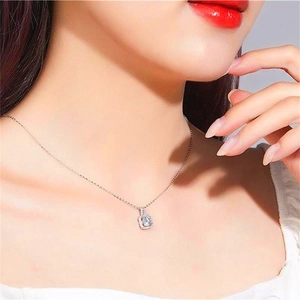 Elegant S925 sterling silver necklace with sparkling square pendant on model's neck