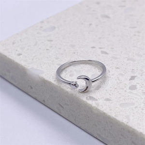 Macro detail of a polished S925 sterling silver adjustable ring with star and moon design