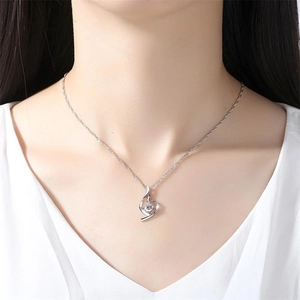 Elegant S925 sterling silver heart pendant necklace with a brilliant round diamond on neck