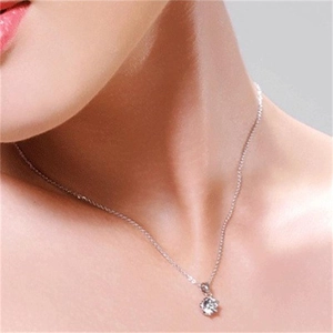 Close-up of S925 silver six-prong cubic zirconia pendant necklace on female model