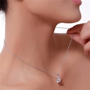 Detail of S925 sterling silver necklace with classic four-prong set round zircon pendant