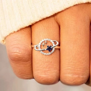 Minimalist S925 silver Saturn planet ring with blue star stone on woman finger