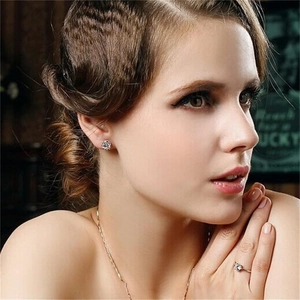 Elegant S925 sterling silver crown earrings and jewelry set worn by a female model