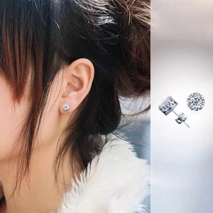 Macro view of S925 sterling silver crown stud earrings with round cubic zirconia on model