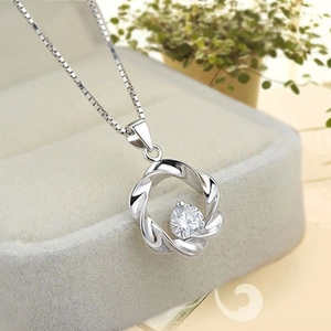 Detail of S925 sterling silver wavy pendant with center zircon in a soft jewelry box