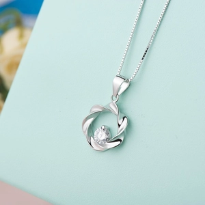 Detailed view of S925 sterling silver wavy pendant with a sparkling central zircon stone