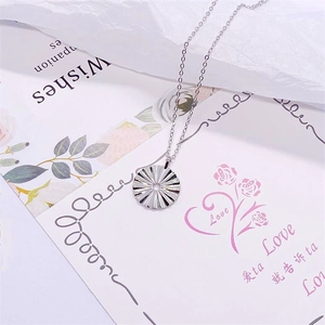 Elegant S925 sterling silver sunburst pendant necklace on a minimalist decorative card