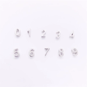 Flat lay of S925 sterling silver DIY jewelry charms featuring numbers 0 to 9