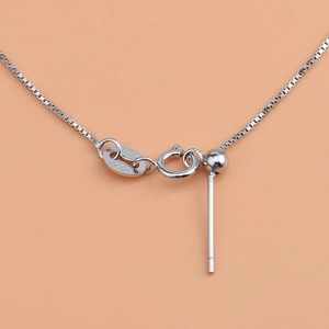 Macro detail of S925 sterling silver box chain with adjustable pin slider and spring clasp