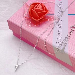Silver number 7 necklace pendant displayed in a pink gift box with a faux rose