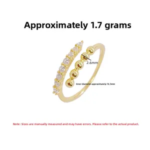 Detail view of adjustable gold-plated silver ring with zircons and beaded design