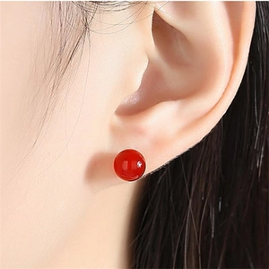 Elegant S925 sterling silver stud earrings with round red agate beads worn by model