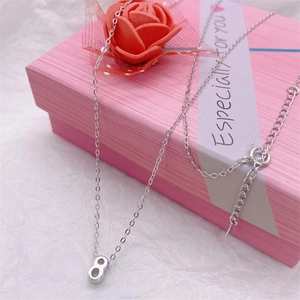 Macro shot of S925 sterling silver figure-8 pendant necklace in a pink gift box
