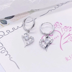 Close-up of S925 silver hollow heart earrings with sparkling round cubic zirconia