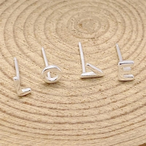 Polished S925 sterling silver alphabet stud earrings set spelling LOVE on wood background
