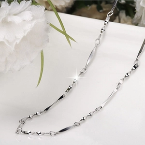 Macro shot of S925 sterling silver twisted chain necklace with polished metal details