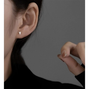 Close-up of minimalist S925 sterling silver stud earring in the shape of letter Y