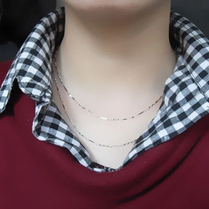 Minimalist S925 sterling silver layered necklace for women on a close-up neck view