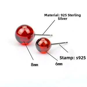 Detailed view of 925 sterling silver studs with 6mm and 8mm garnet red beads