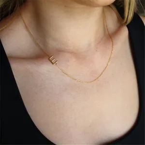 Close-up of a gold-plated S925 sterling silver necklace featuring the initial letter E