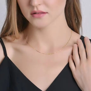 Close-up of minimalist S925 sterling silver gold-plated necklace on a model's collarbone