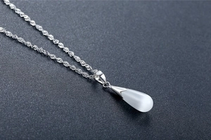 Macro view of S925 sterling silver hallmark on teardrop opal necklace pendant