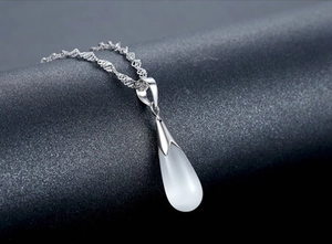 Close-up of teardrop opal pendant necklace with elegant silver rope chain detail