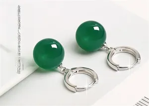 Macro shot of S925 sterling silver hoop earrings with translucent green agate beads