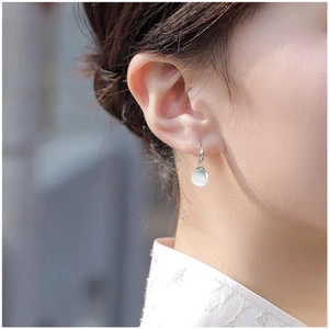 Elegant S925 sterling silver drop earrings with round white opal stones on model