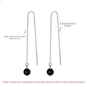 Detail of 8cm silver box chain drop earrings featuring smooth black agate bead charms
