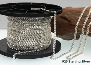 Detailed close-up of S925 sterling silver curb chain links on a black plastic reel