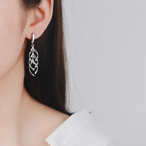 Elegant S925 sterling silver long spiral twist earrings worn by a female model