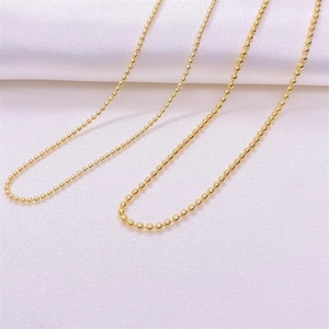 Macro detail of polished gold-plated S925 sterling silver ball chain necklace for women
