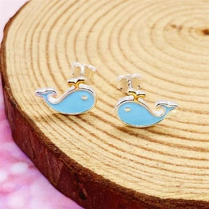 S925 sterling silver blue whale studs with enamel finish on natural wood background