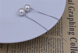 Detail of long S925 sterling silver threader earrings with white 8mm round pearls
