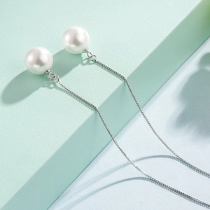 Elegant S925 sterling silver long drop earrings with white pearls in a minimalist design