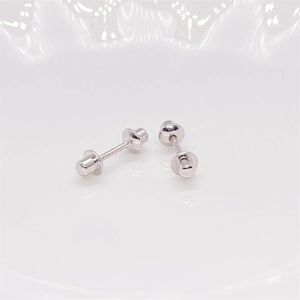 Macro shot of silver bullet screw-back earrings showing precision threads and polished finish