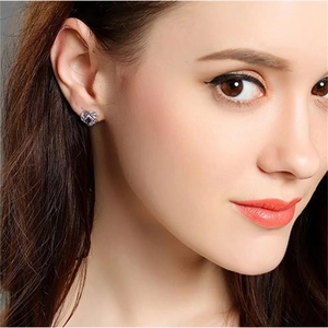 S925 sterling silver four-leaf clover earrings with purple zircon on a model