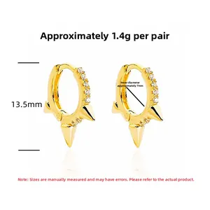 Detail of gold spike hoop earrings with zircon inlay weighing 1.4g and 13.5mm height